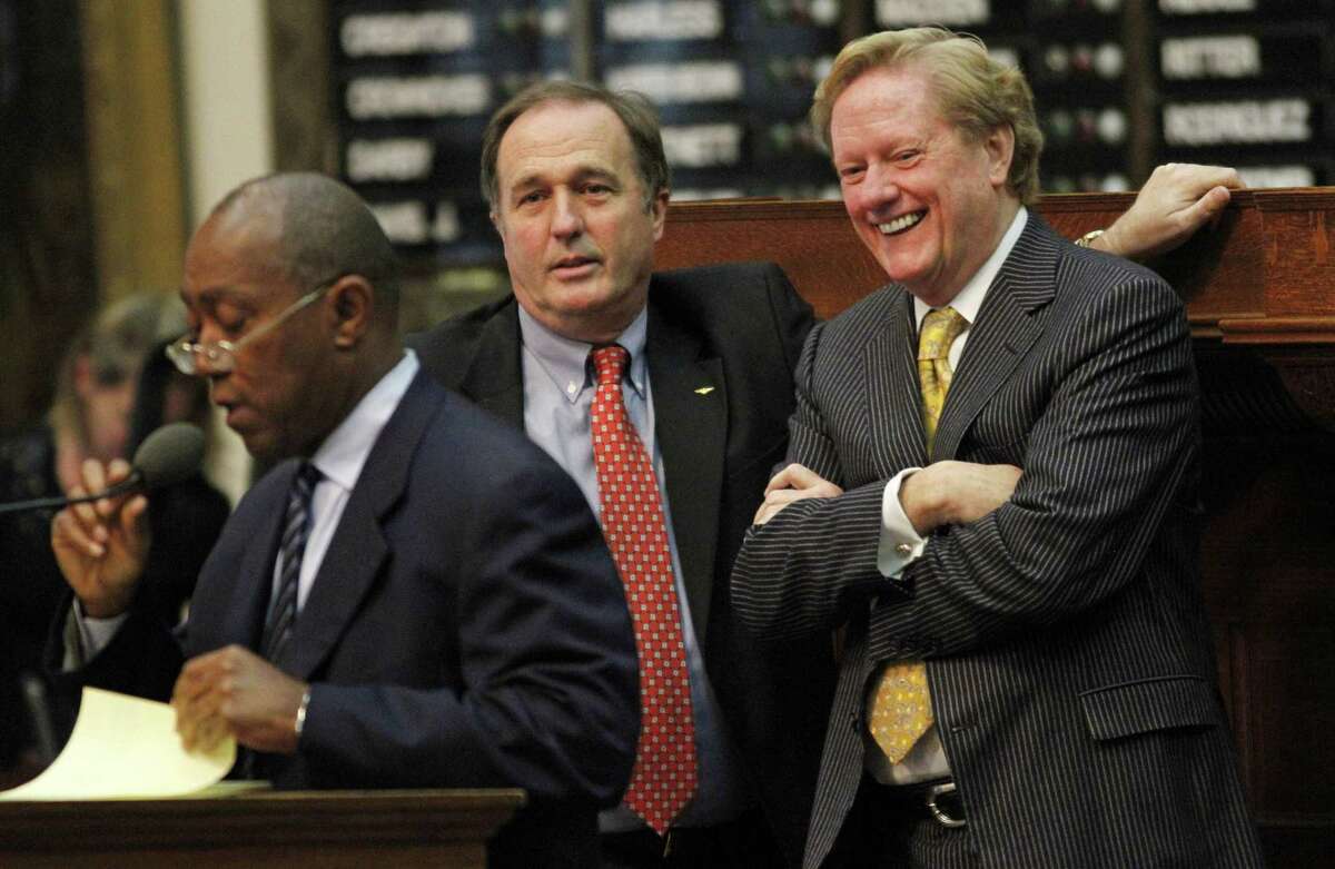 Rep. Jim Pitts, R- Waxahachie, right, and Rep. Rob Eissler, R- The Woodlands, talk while Rep. Sylvester Turner, D- Houston, left, debates in opposition to a bill to help balance the state budget and change public school funding formulas in Austin, Texas on Sunday, May 29, 2011. The House then quickly approved the final version of the bill 84-63. (AP Photo/Jack Plunkett)