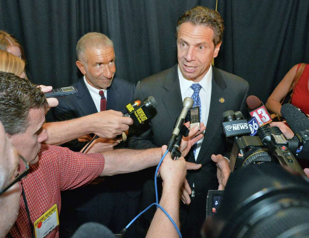 Gov. Andrew Cuomo, right, and Albany Nanotech founder Alain Kaloyeros speak with reporters following an announcement in 2014. (John Carl D'Annibale / Times Union)