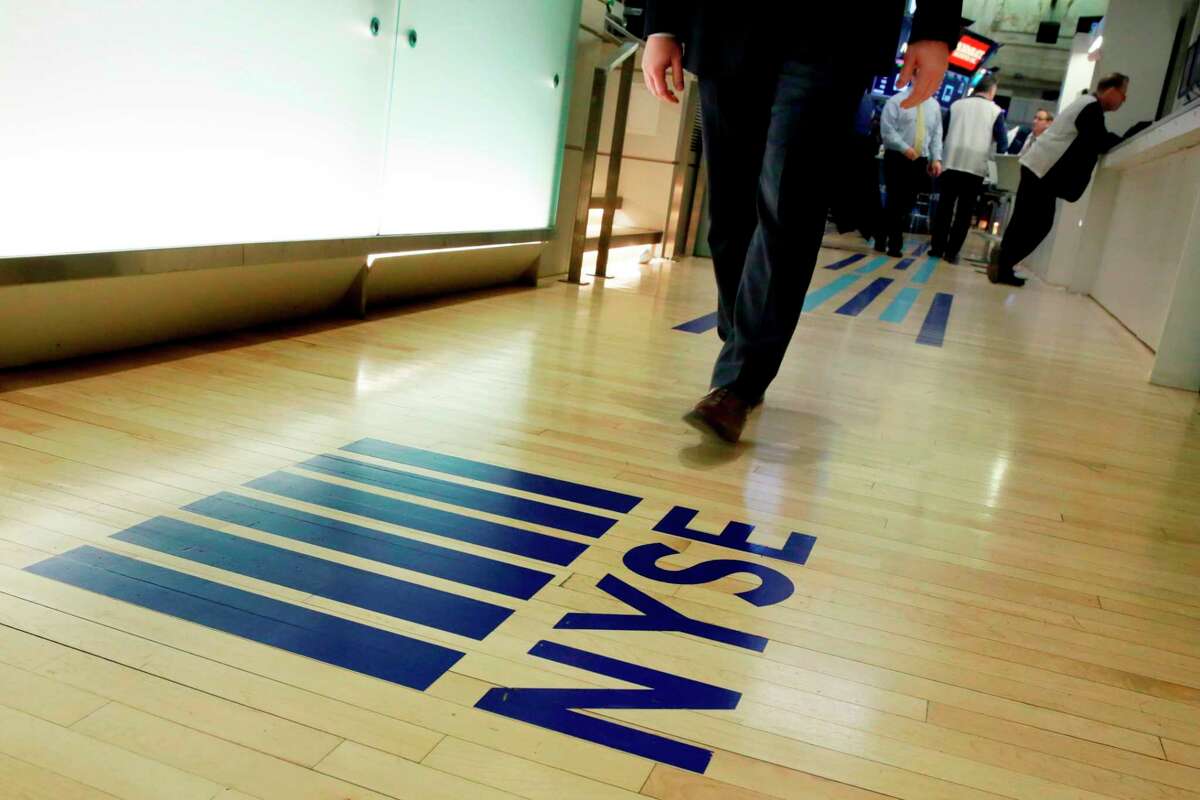FILE- In this April 5, 2018, file photo, an NYSE logo adorns the entrance to the trading floor the New York Stock Exchange. Never has it been so cheap to put money into the market, and it?’s about to get even cheaper following Vanguard?’s recent decision to end online commissions for most ETFs. (AP Photo/Richard Drew, File)