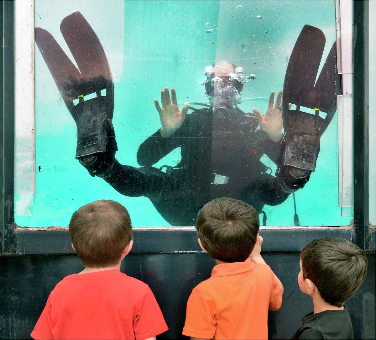 Trooper Paul Tieback of the NYSP Troop G underwater recovery team puts on a demonstration for children during Kids Day at the Plaza Saturday July 14, 2018 in Albany, NY. (John Carl D'Annibale/Times Union)