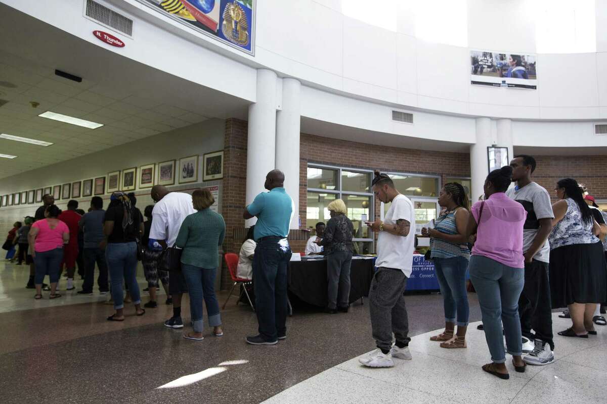 People line up for legal services during the Make It Right! program at North Shore High School on Saturday, July 14, 2018, in Houston. Make It Right! is designed to help members of the community, with low-level, non-violent misdemeanor offenses, have outstanding warrants removed and pending cases resolved with no immediate financial cost and no risk of arrest. ( Brett Coomer / Houston Chronicle )
