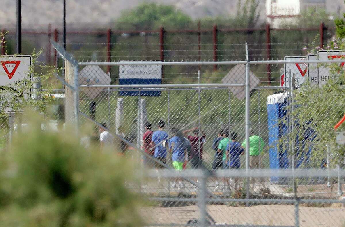 FILE - In this June 21, 2018 file photo, detainees are seen inside a facility, where tent shelters are being used to house separated family members at the Port of Entry in Fabens, Texas. The separation of families at the U.S.-Mexico border caught the attention of the world and prompted mass outrage, but it only tells a small part of the story surrounding the Trump administration?’s immigration policy. (AP Photo/Matt York, file)
