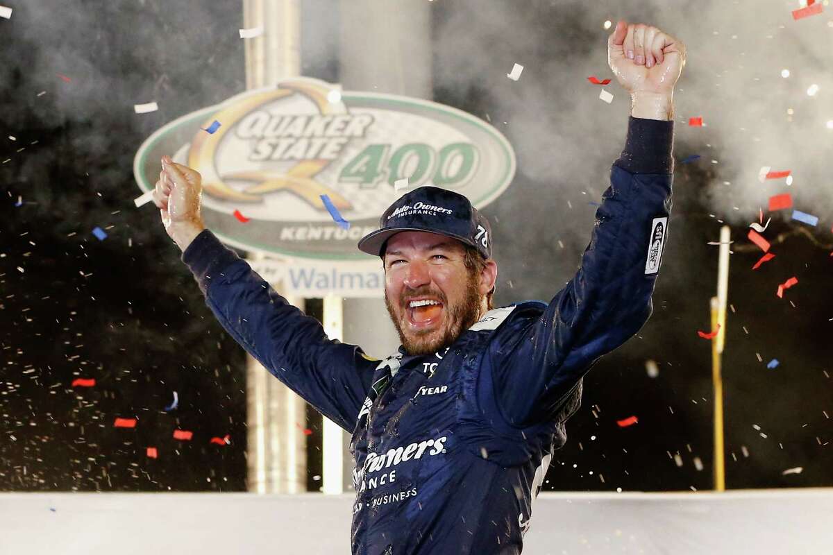 SPARTA, KY - JULY 14: Martin Truex Jr., driver of the #78 Auto-Owners Insurance Toyota, celebrates in Victory Lane after winning the Monster Energy NASCAR Cup Series Quaker State 400 presented by Walmart at Kentucky Speedway on July 14, 2018 in Sparta, Kentucky. (Photo by Brian Lawdermilk/Getty Images)