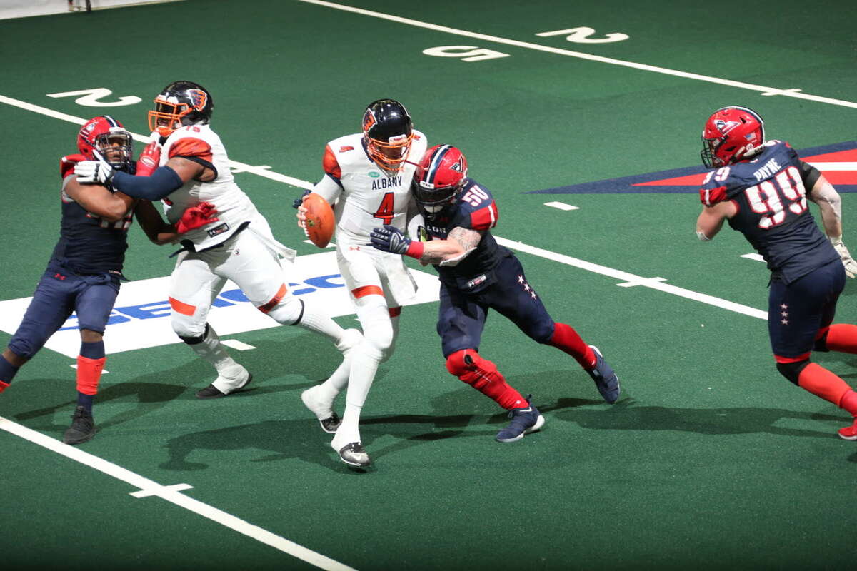 Albany quarterback Tommy Grady tries to escape the Washington defense in the Empire's 57-56 overtime win in the first round of the playoffs in Washington on Saturday, July 14, 2018. (Courtesy of Albany Empire)