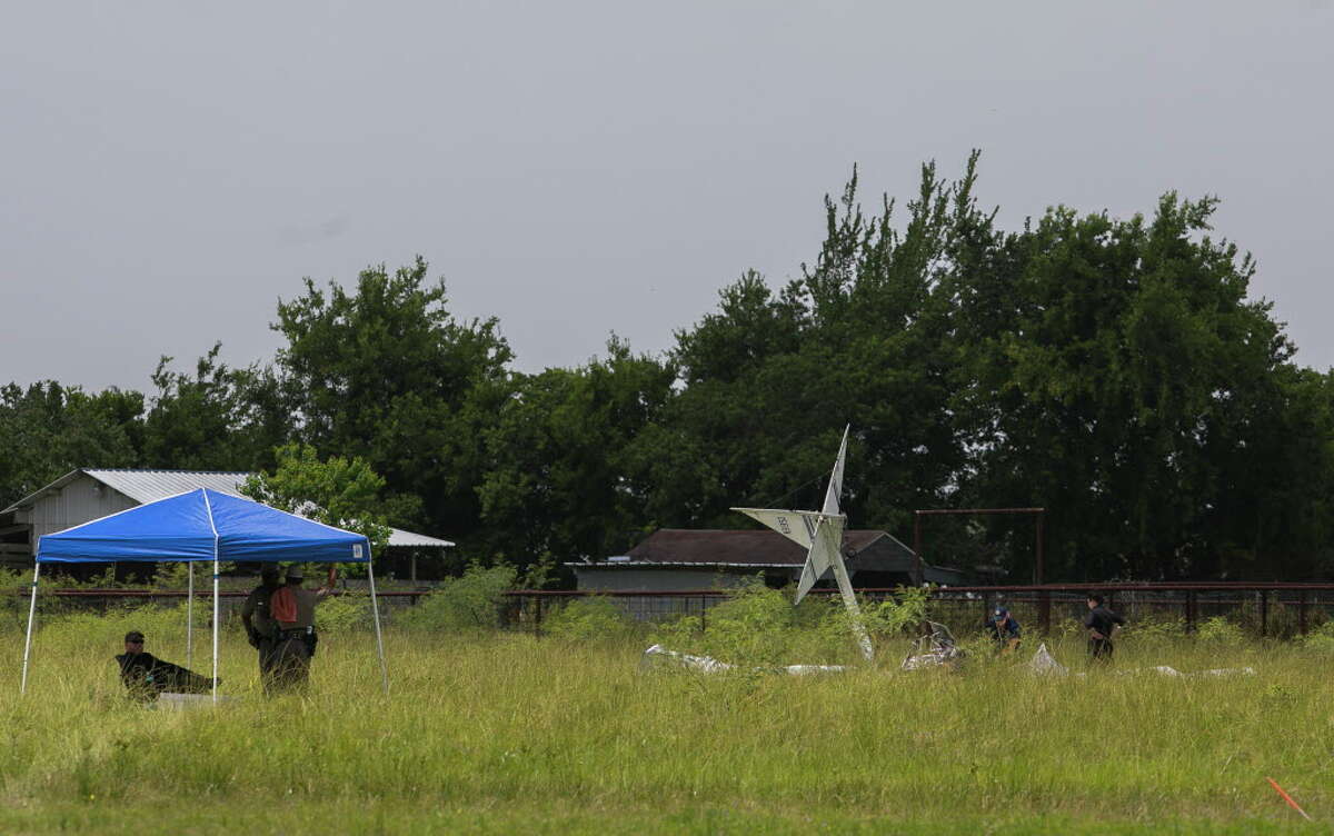 Investigators examine the site of a fatal plane crash that killed two people when the plane went down just north of the La Porte Municipal Airport, Saturday morning, July 14, 2018. An Experimental Kolb Twinstar II was heading into the north side of the La Porte Municipal Airport just before 10 a.m. when it went down about 300 yards from the end of the runway, according to the Federal Aviation Administration.