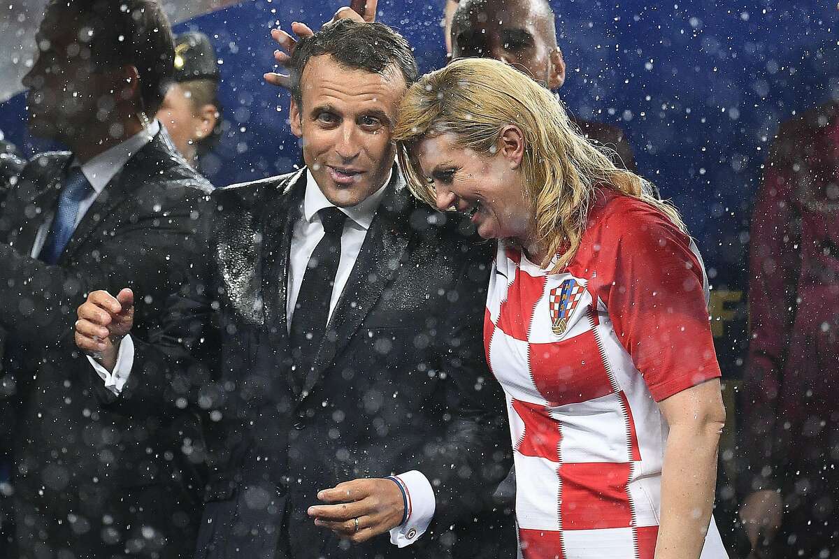 French President Emmanuel Macron (L) talks with Croatian President Kolinda Grabar-Kitarovic during the trophy ceremony at the end of the Russia 2018 World Cup final football match between France and Croatia at the Luzhniki Stadium in Moscow on July 15, 2018. / AFP PHOTO / FRANCK FIFE / RESTRICTED TO EDITORIAL USE - NO MOBILE PUSH ALERTS/DOWNLOADS FRANCK FIFE/AFP/Getty Images