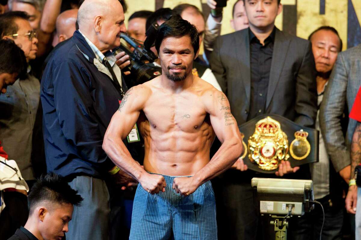 Philippine senator and boxing hero Manny Pacquiao poses after weigh-in in Kuala Lumpur, Malaysia, Saturday, July 14, 2018. Matthysse and Pacquiao are scheduled to fight on July 15, for the World Boxing Association welterweight title in Malaysia. (AP Photo/Yam G-Jun)