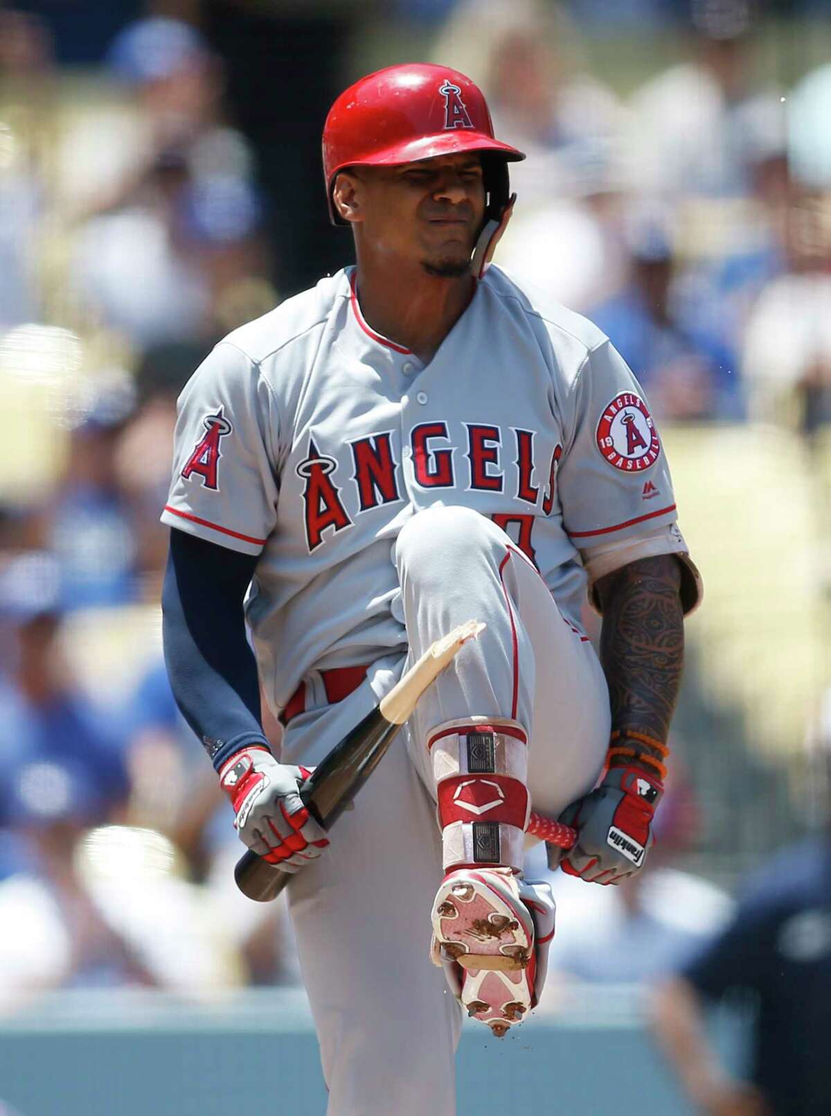 Los Angeles Angels Jefry Marte breaks his bat over his leg after striking out on a full count pitch from Los Angeles Dodgers starting pitcher Clayton Kershaw, not pictured to end the top of the first inning of a baseball game leaving the bases loaded Sunday, July 15, 2018, in Los Angeles. (AP Photo/Danny Moloshok)