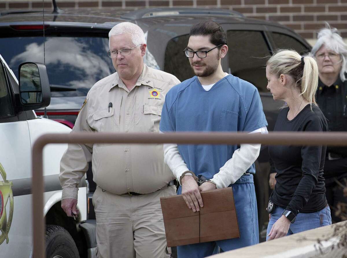 Marq Vincent Perez, who is accused of intentionally setting a fire that destroyed a mosque in Victoria, is escorted from the federal courthouse in Victoria after a Jan. 11 pretrial hearing. After hearing five days of trial testimony, the 12 jurors began deliberating early Monday afternoon.