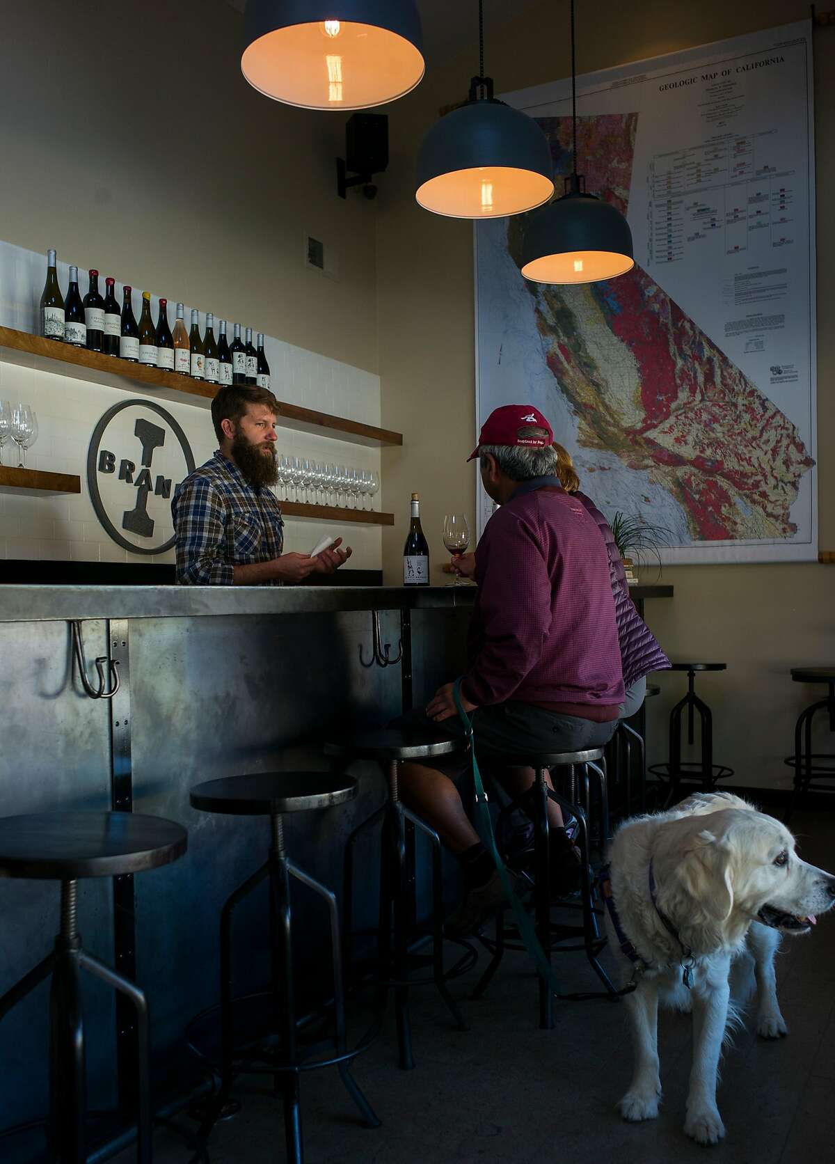 Winemaker Ian Brand (left) talks with customers at the I. Brand and Family tasting room in Carmel Valley, Calif.