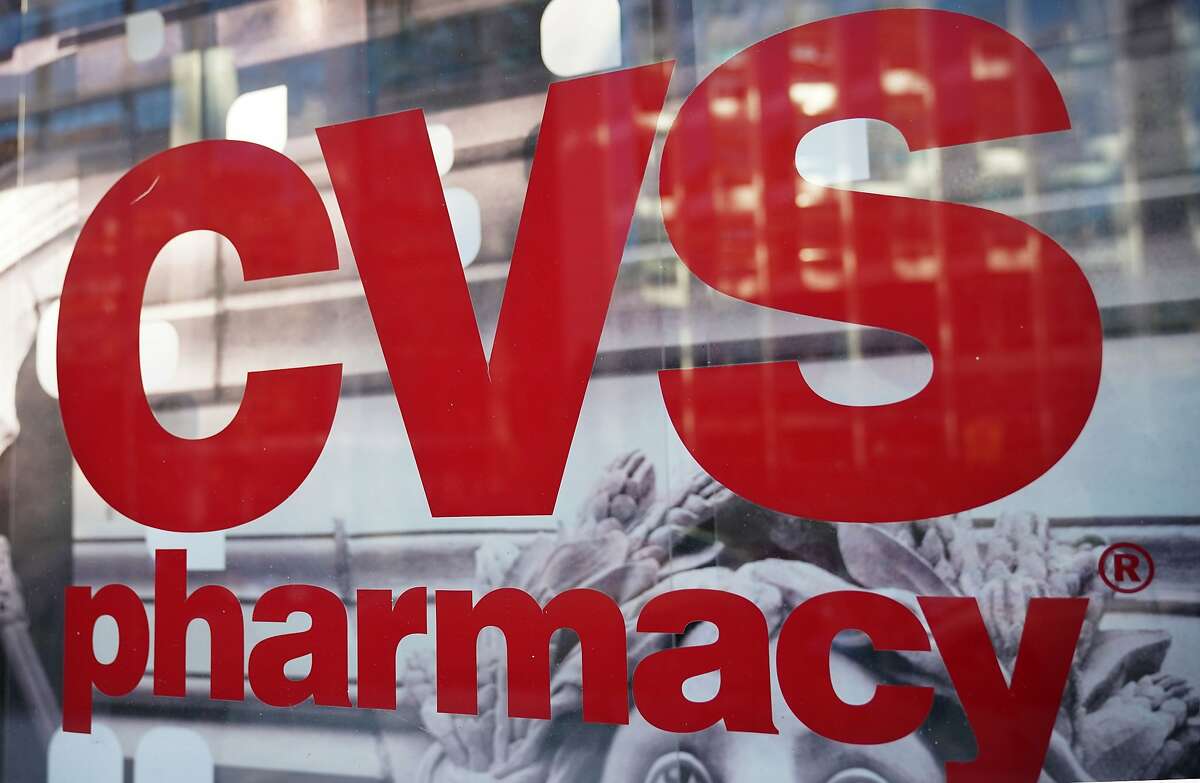 In this file photo taken on December 3, 2017, the CVS logo is seen in front of one of its stores.