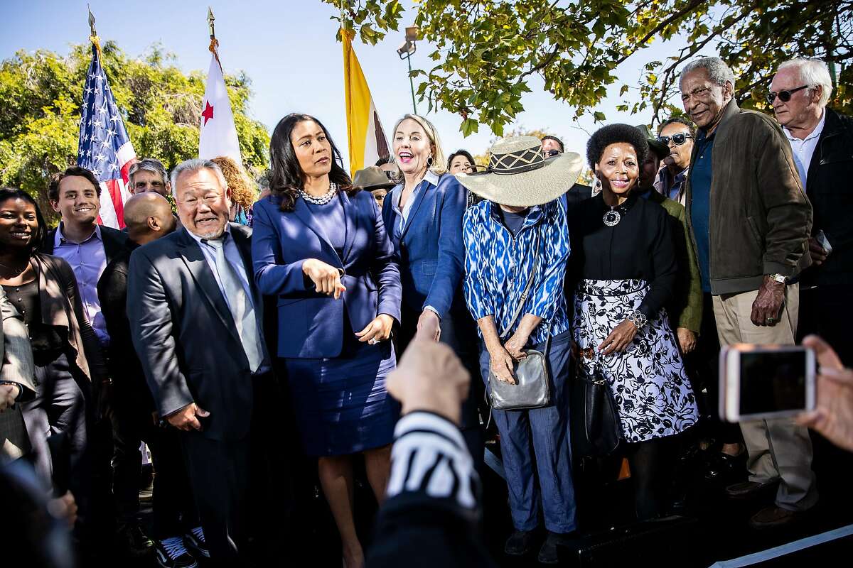 Mayor London Breed and newly appointed District 5 Supervisor Vallie Brown smile as they stand for a group photo following Brown's swearing-in ceremony at the Hayes Valley Playground in San Francisco, Calif. on Monday, July 16, 2018.