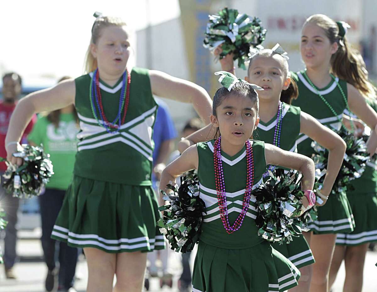 Garden Oaks Montessori cheerleaders march during the Crawfish Festival in the Heights parade Saturday, March 5, 2016, in Houston. ( James Nielsen / Houston Chronicle )