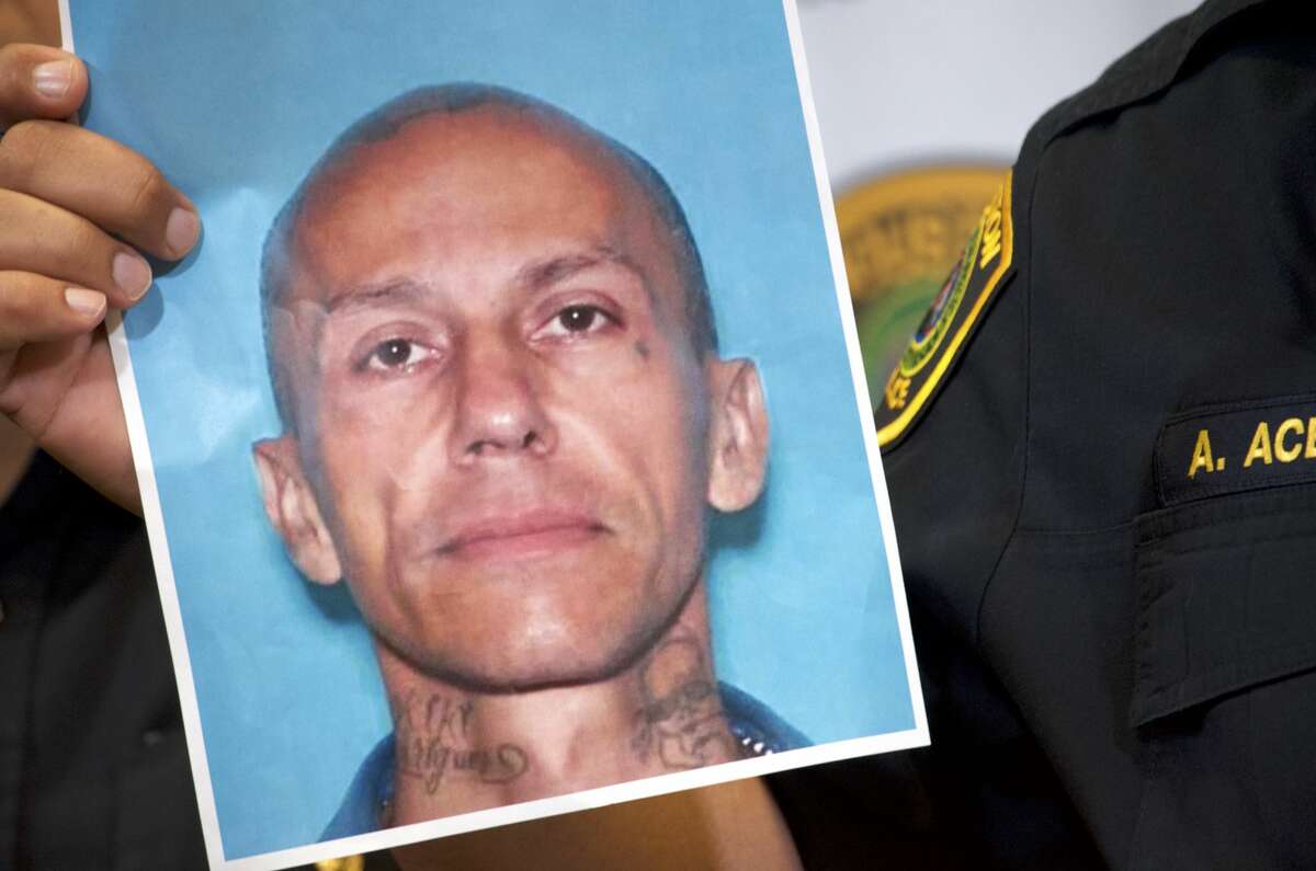 Houston Police Chief Art Acevedo holds up a photo of Jose Gilberto Rodriguez, 46, on Monday July 16, 2018. Rodriguez is accused in three separate killings and two other violent robberies.