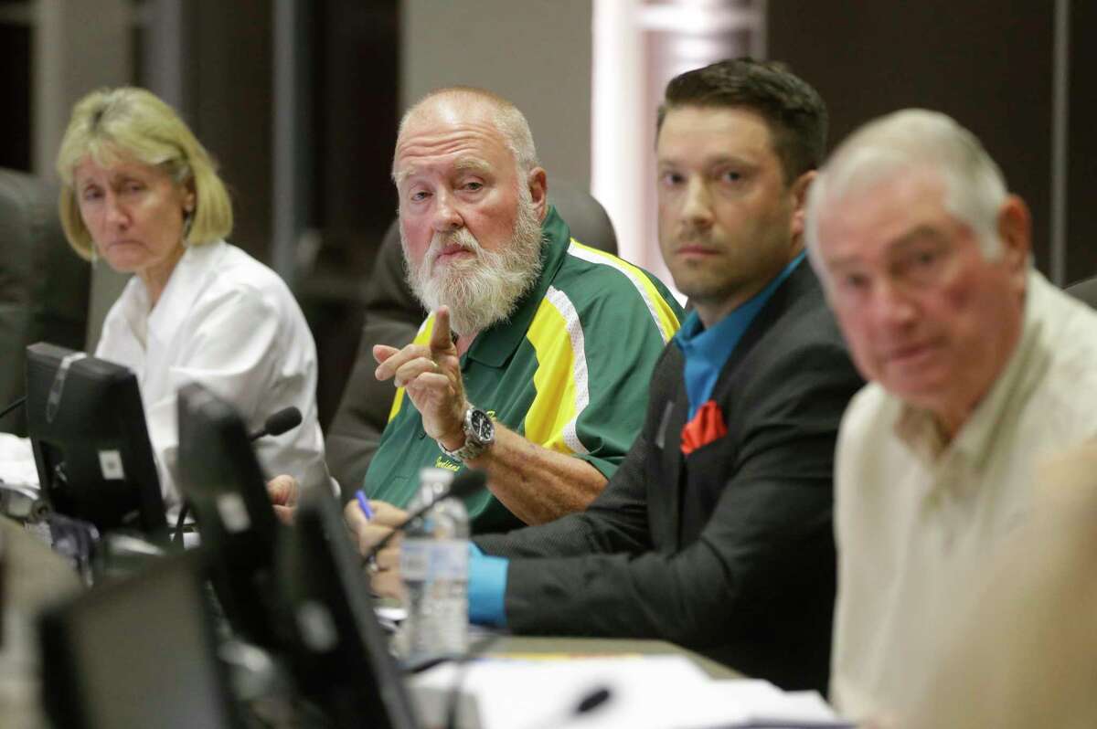 Superintendent Leigh Wall, left, J. R. “Rusty” Norman, president, Eric E. Davenport, and John Rothermel, vice president, right, area shown during the Santa Fe ISD trustees meeting Monday, July 16, 2018, in Santa Fe. They voted to install metal detectors in each of the district's schools. Continue clicking to see images captured on the day of the tragic shooting and its aftermath.