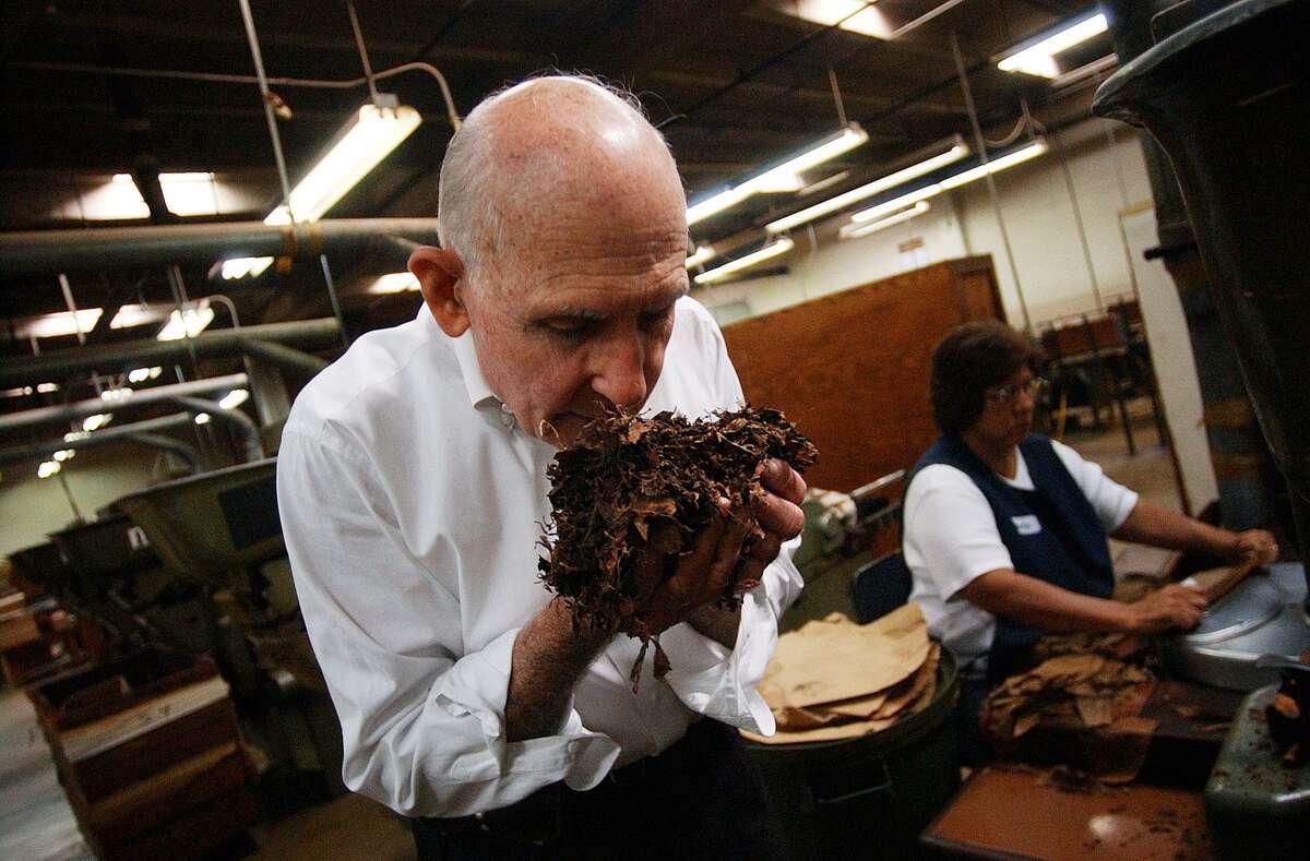 Owner Bill Finck of the Finck Cigar Company breaths in a handful of freshly shredded tobacco that's used as the filler in his cigars on Friday, Aug. 13, 2004. Finck died July 10, 2018 at the age of 87.