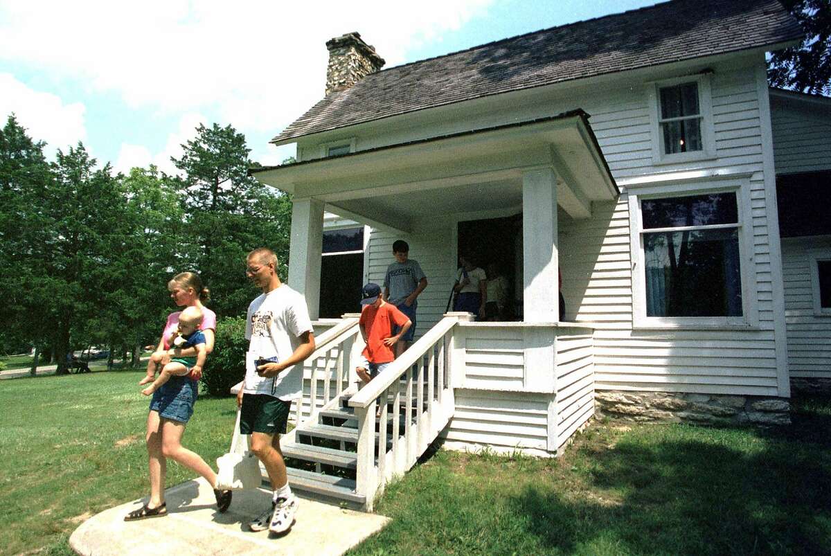FOR IMMEDIATE RELEASE--Visitors exit the Laura Ingalls Wilder home in Mansfield, Mo., Aug. 4, 2000, following a tour of the homestead. Last year, nearly 50,000 people toured the home and museum, which is on the National Registry of Historical Places. (AP Photo/John S. Stewart)