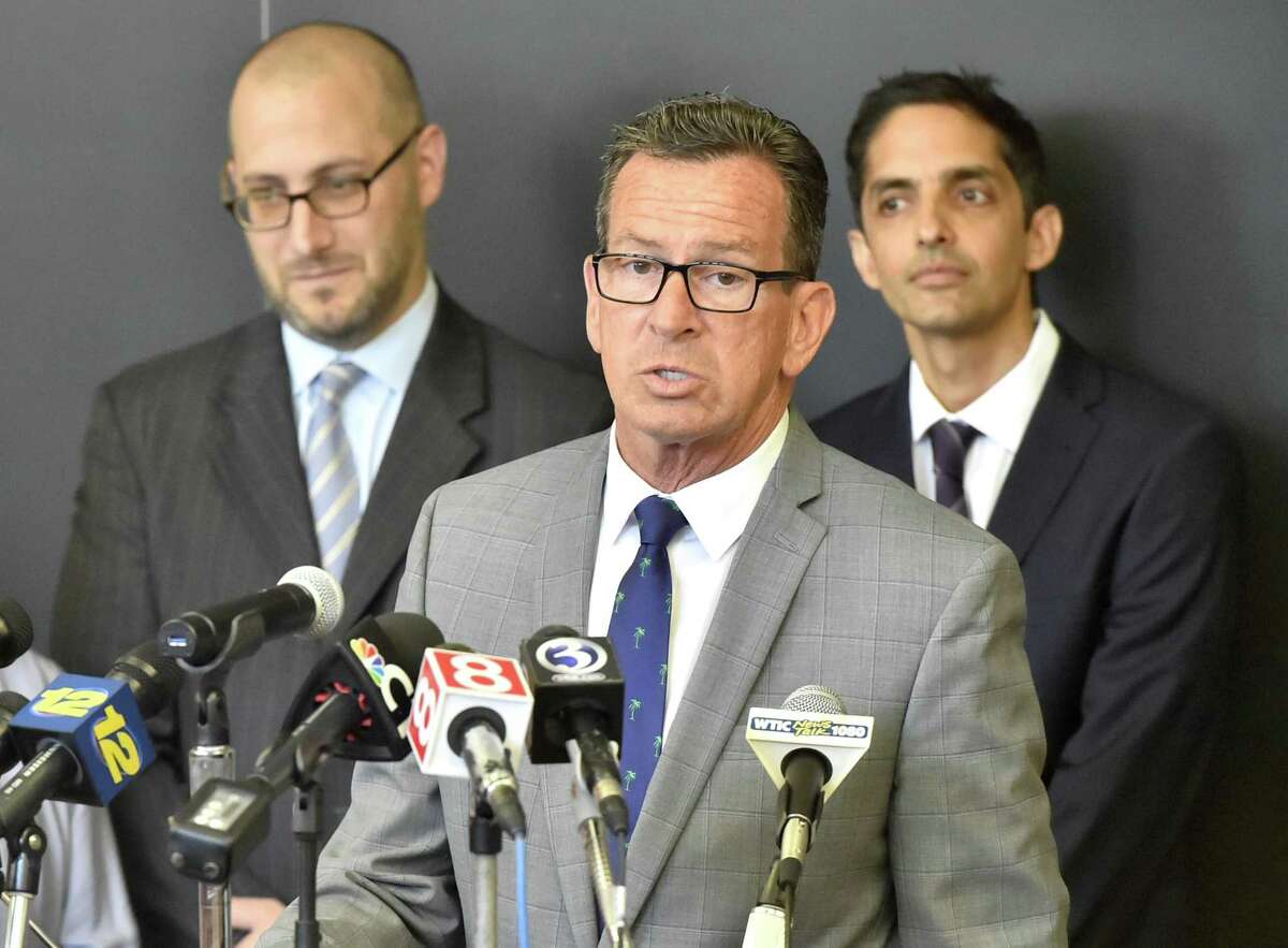 Deputy director of Connecticut Legal Services, Josh Perry, Yale Law School Professor Muneer Ahmad of the Worker and Immigrant Rights Advocacy Clinic, and Connecticut Governor Dannel P. Malloy, left to right, during a press conference Tuesday at the Yale Law School discussing the litigation of the emergency lawsuits they filed on behalf of 2 immigrant children from Honduras and El Salvador that led to their release and reunification with their families recently as a result of a federal judges finding that the children's constitutional rights were violated.