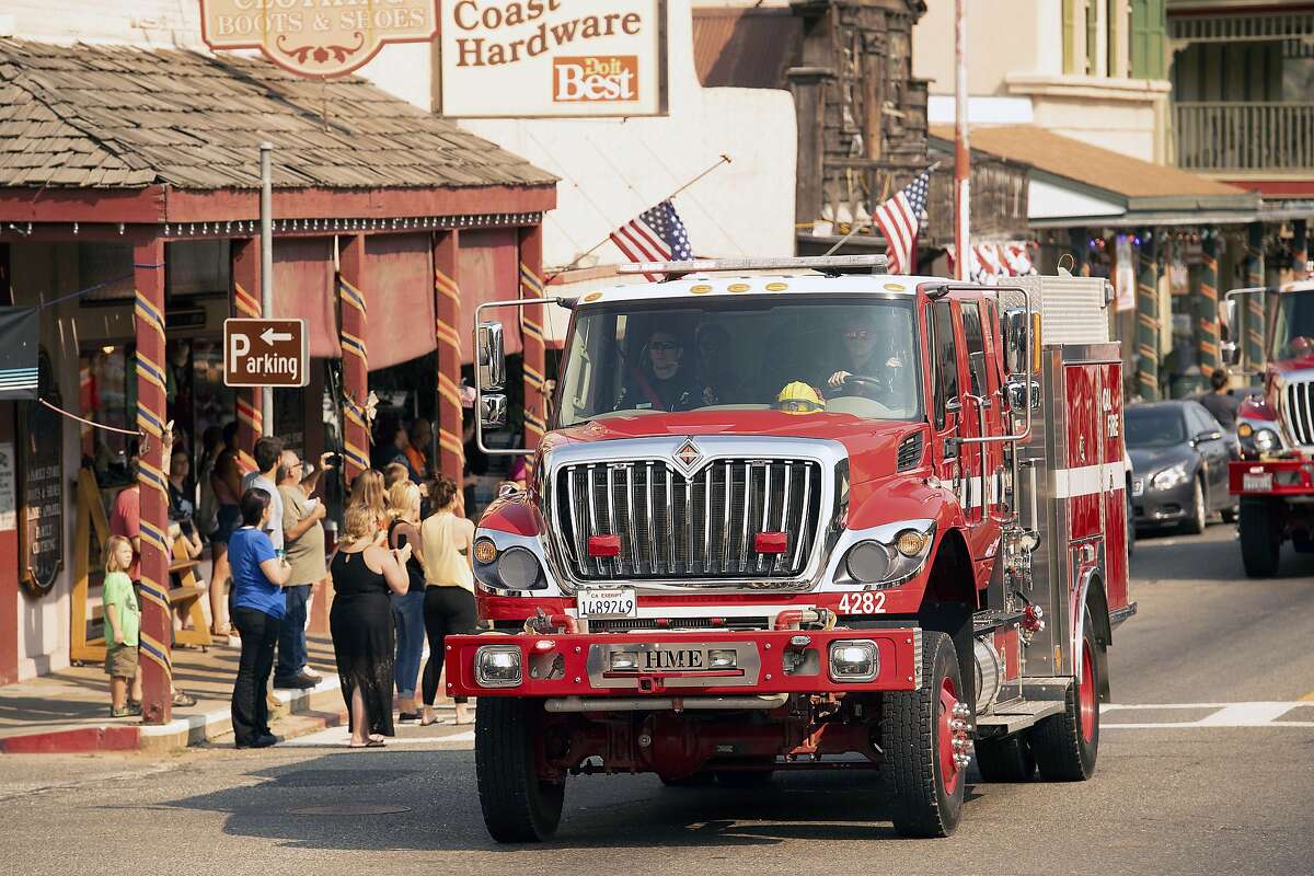 A fire truck, part of a procession carrying the body of firefighter Braden Varney, makes its way along Highway 140 on Monday, July 16, 2018, in Mariposa, Calif. Varney died when his bulldozer overturned as he battled the Ferguson fire. (AP Photo/Noah Berger)