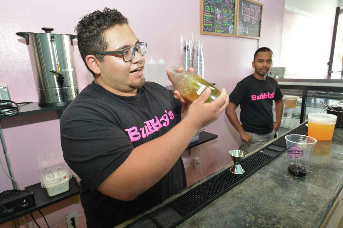 Owner Henry Limon shakes up a green apple fruit tea with mango bursting bubbles alongside co owner Sabbir Hossain at their store Bubbly's on Washington St. in Norwalk Conn. on Thursday July 12 2018.