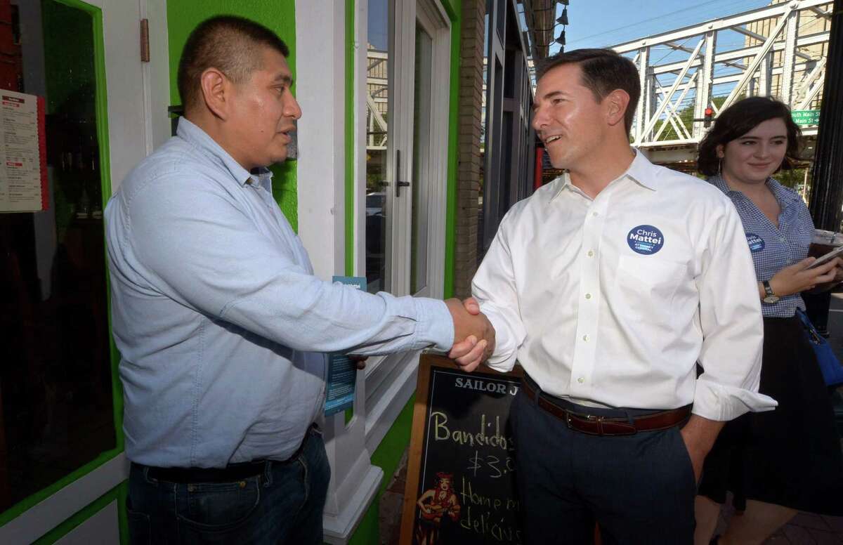 Democrat primary candidate for Connecticut Attorney General, Chris Mattei, right, greets Bandito Mexican restaurant owner, Jose Corona, as Mattei campaigns through South Norwalk for a small business/neighborhood tour Thursday, July 12, 2018, in Norwalk, Conn.