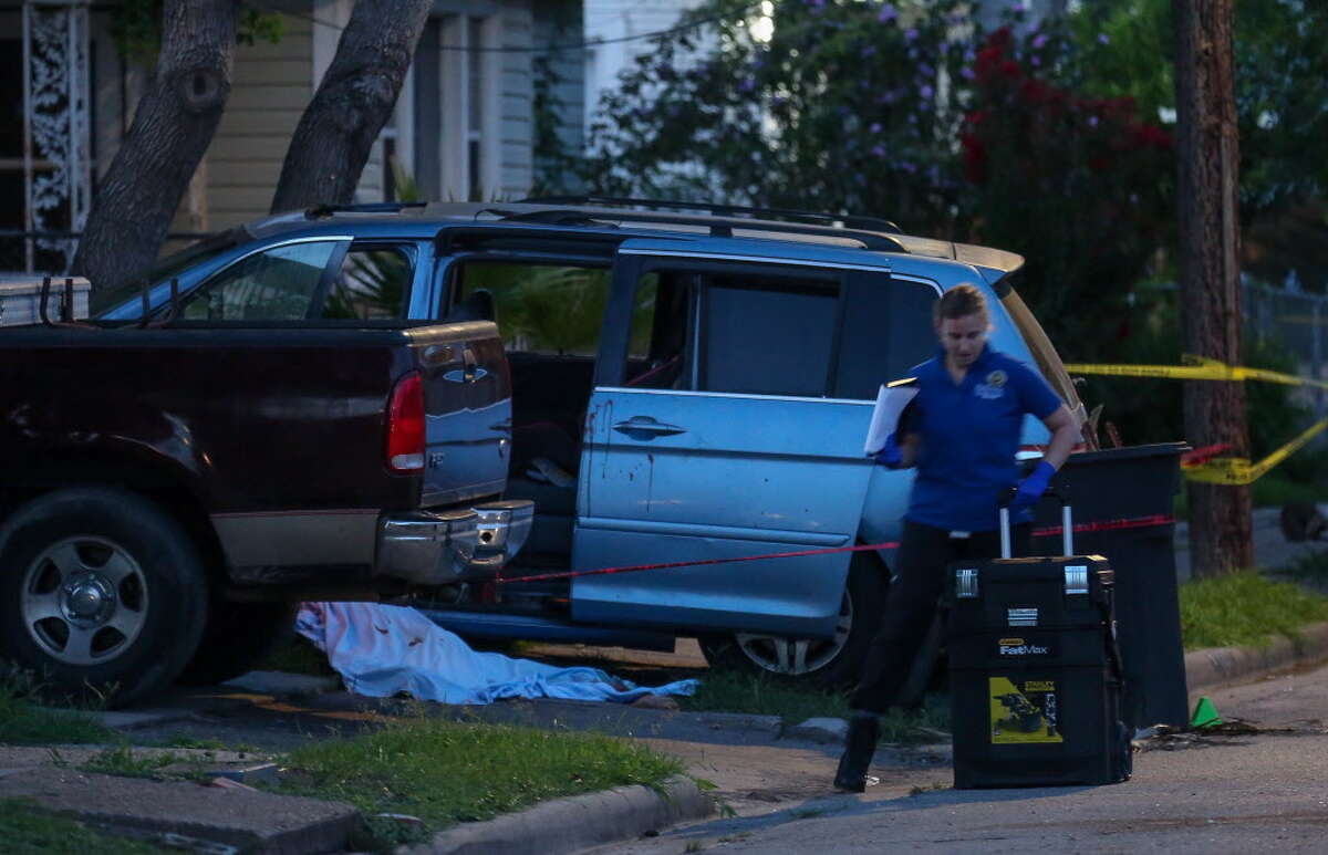 A member of the Houston Forensic Science Center works the scene where a man died on the intersection of Maltby Street and Avenue L, after being shot overnight Wednesday, July 18, 2018, in Houston.