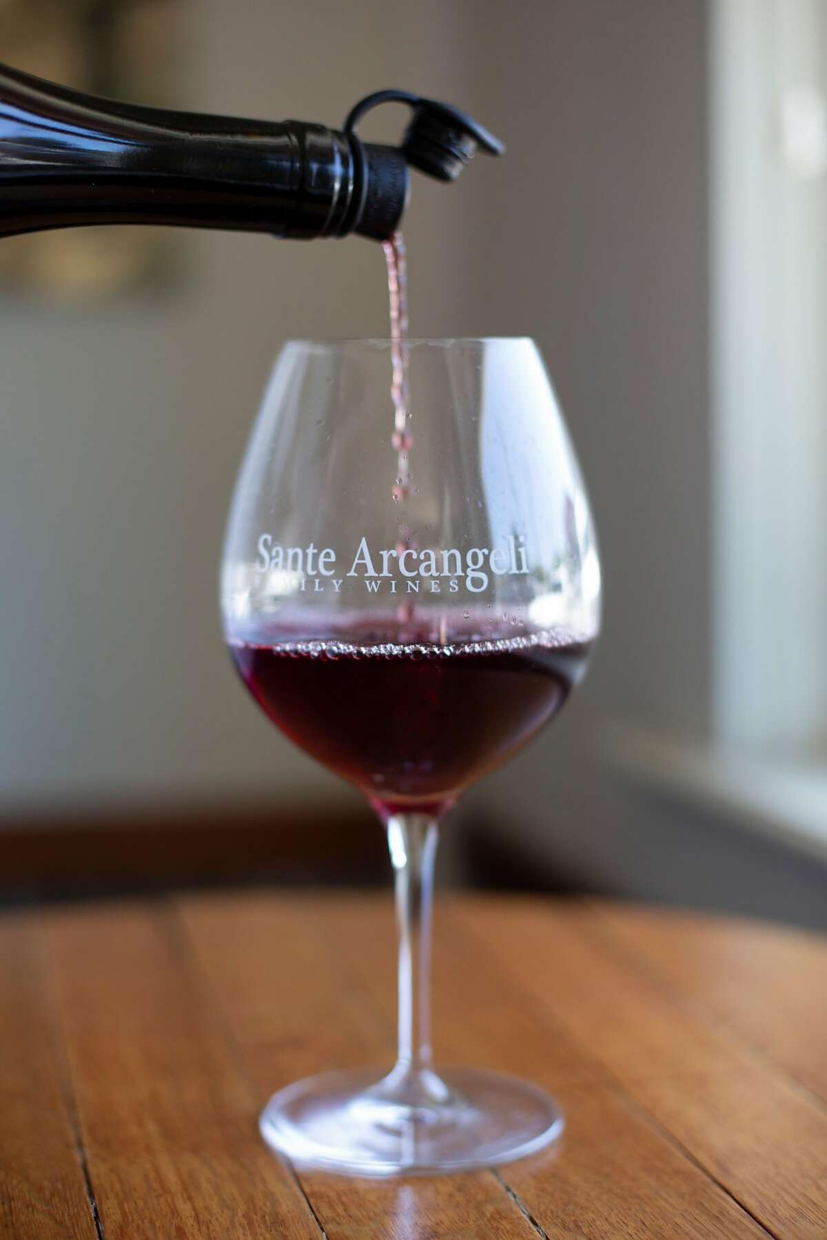 Employee John Marshall pours a glass of 2016 Pinot Noir, Split Rail Vineyard, at Sante Arcangeli Family Wines' tasting room in Pescadero, Calif. on Saturday, June 23, 2018.