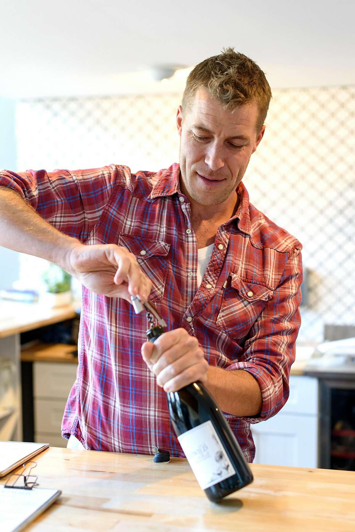 Owner Sam Bilbro opens a bottle of the 2014 Nebbiolo at Idlewild Wines tasting room in Healdsburg, Calif., on Friday June 29, 2018.