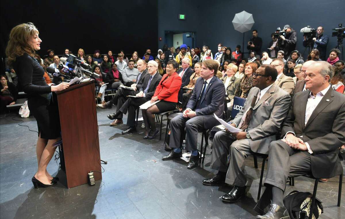 (Peter Hvizdak - New Haven Register) University of Connecticut President Susan Herbst, left at podium, announced Tuesday, December 1, 2015 that UConn is committing $5000 in scholarship money to each New Haven Promise scholar attending UConn, starting in the fall 2016 to help ensure that college is affordable and accessible to them. Herbst announced the financial commitment at New Haven's Cooperative Arts and Humanities High School. She was joined by, left to right first row seating, New Haven Superintendent of Schools Garth Harries, Yale President Peter Salovey, who is New Haven Promise's board chair, New Haven Mayor Toni Harp, 96th District State Representative Roland Lemar, former New Haven Superintendent of Schools Reginald Mayo and former New Haven Mayor John DeStefano.