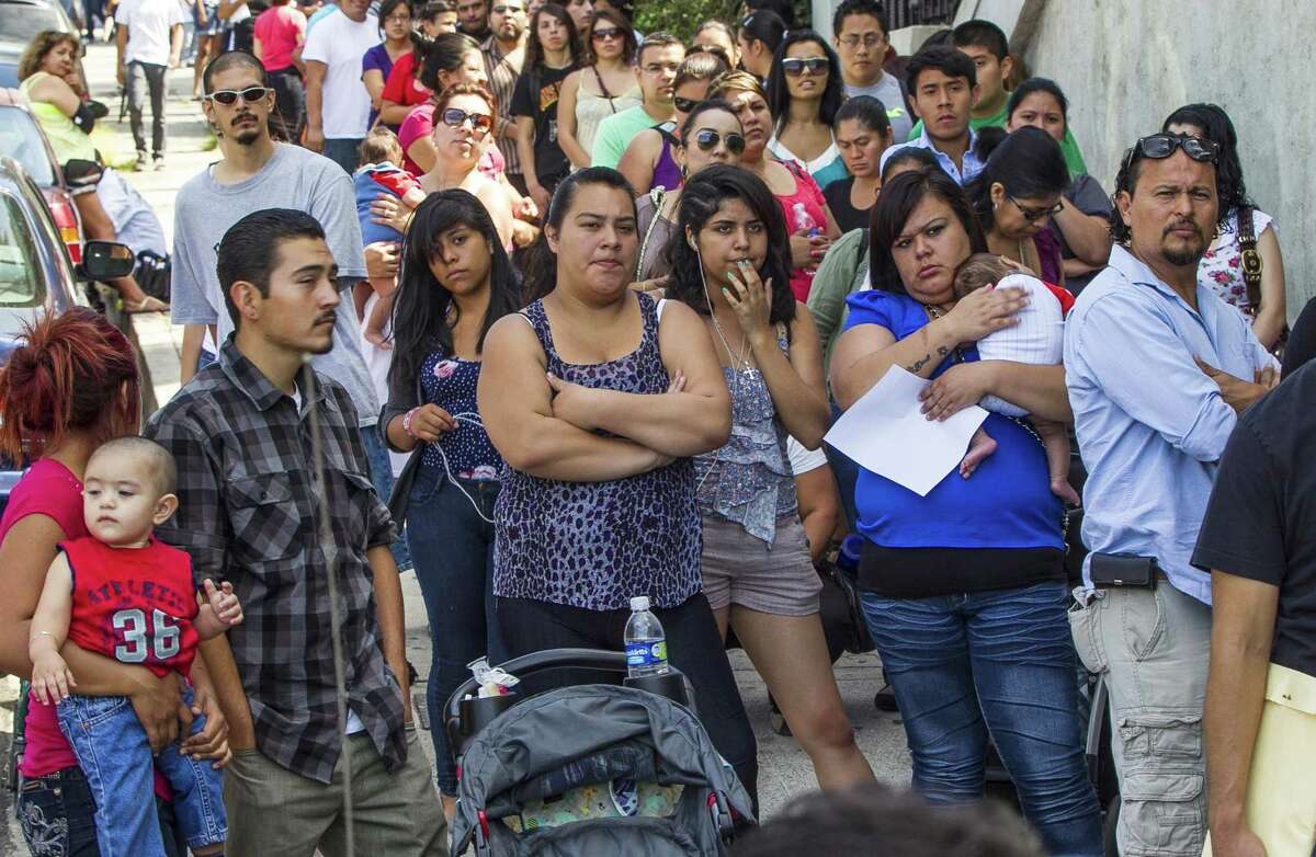 In this Aug. 15, 2012, file photo, a line of people living in the U.S. without legal permission wait outside the Coalition for Humane Immigrant Rights in Los Angeles. California is suing the Trump administration over its decision to add a question about citizenship to the 2020 U.S. Census. In announcing the lawsuit Tuesday, March 27, 2018, California Attorney General Xavier Becerra says adding such a question is a reckless decision that would violate the U.S. Constitution and cause a population undercount.
