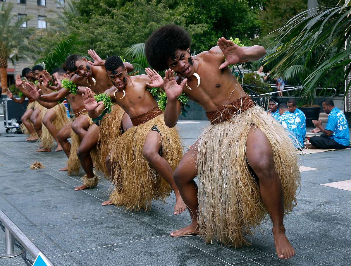 Jope Kalou (right) and other Fijian dancers perform a "meke" dance at Union Square in San Francisco, Calif. on Tuesday, July 17, 2018. The performances by the Kabu ni Vanua dancers are ahead of the Fiji rugby seven team's appearance in the Rugby World Cup Sevens tournament this weekend at AT&T Park.
