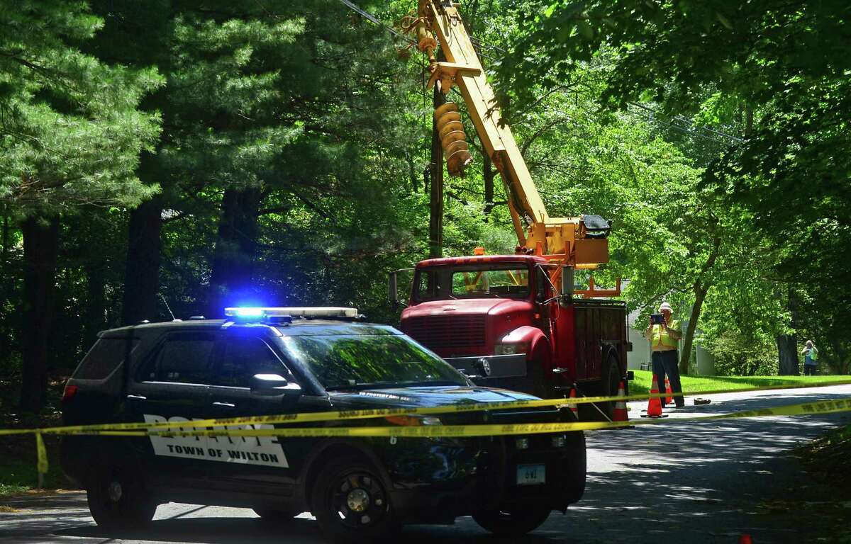 Wilton Police and Eversource employees investigate a workplace accident scene on Rivergate Drive in Wilton that killed 44-year-old Marco Silva of Danbury on June 9, 2016. Silva’s widow has filed a lawsuit against Eversource and his employer, KTI Utility Construction & Maintenance LLC.