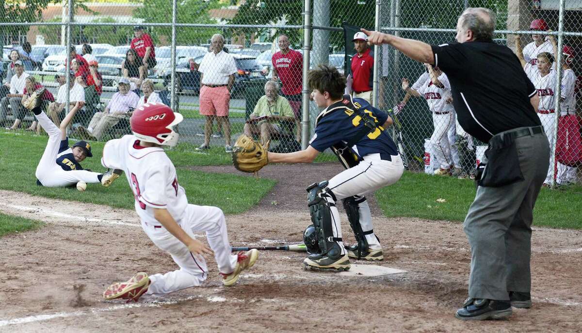 Weston Dylan Delaney attempts to get the force out with bases loaded catcher Michael Amato (31) on Fairfield American Robbie Donahue (13), who scored on a bunt by Timmy Donahue (9) in the fourth inning of a Section 1 Little League tournament baseball game on July 18, 2018 in Stamford, Connecticut. Fairfield American won 1-0.