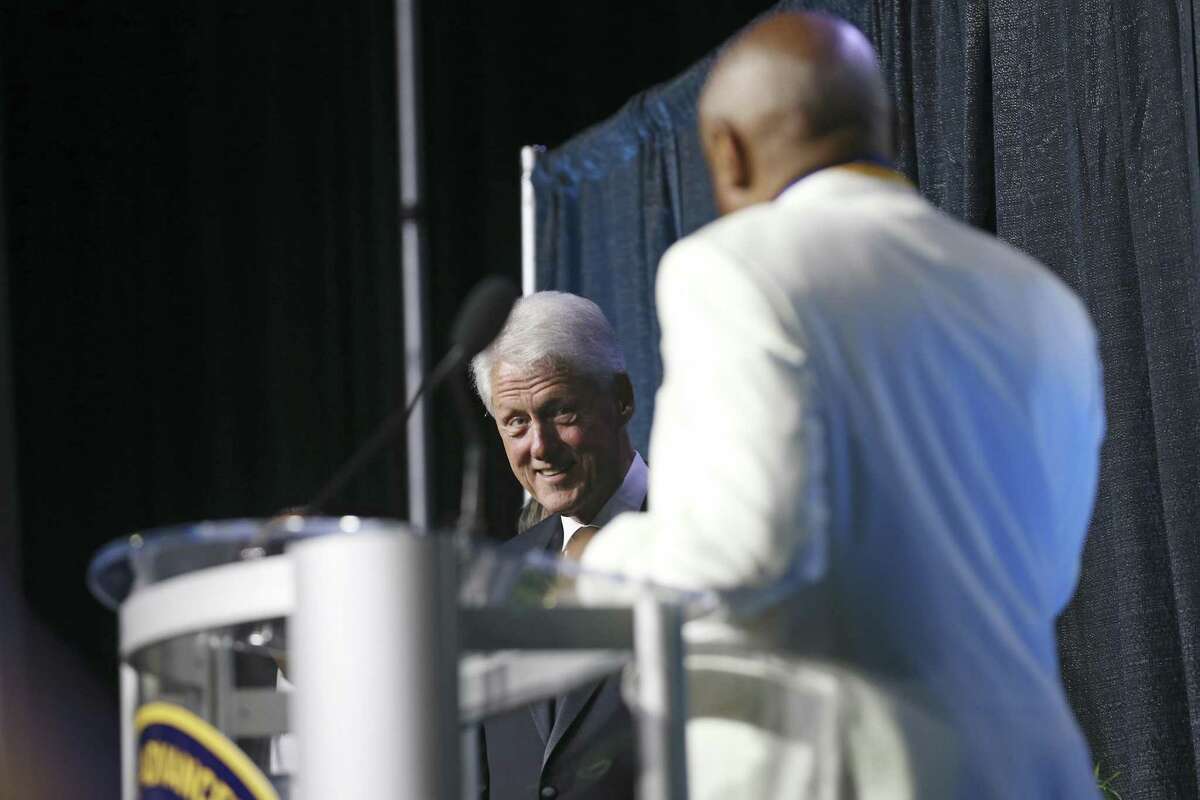 President Bill Clinton reacts to comments from former San Francisco Mayor Willie L. Brown after Clinton presented him with the Thalheimer Spingarn Medal during the 109th annual National Association for the Advancement of Colored People convention at the Henry B. Gonzalez Convention Center in San Antonio, Texas, Wednesday, July 18, 2108.