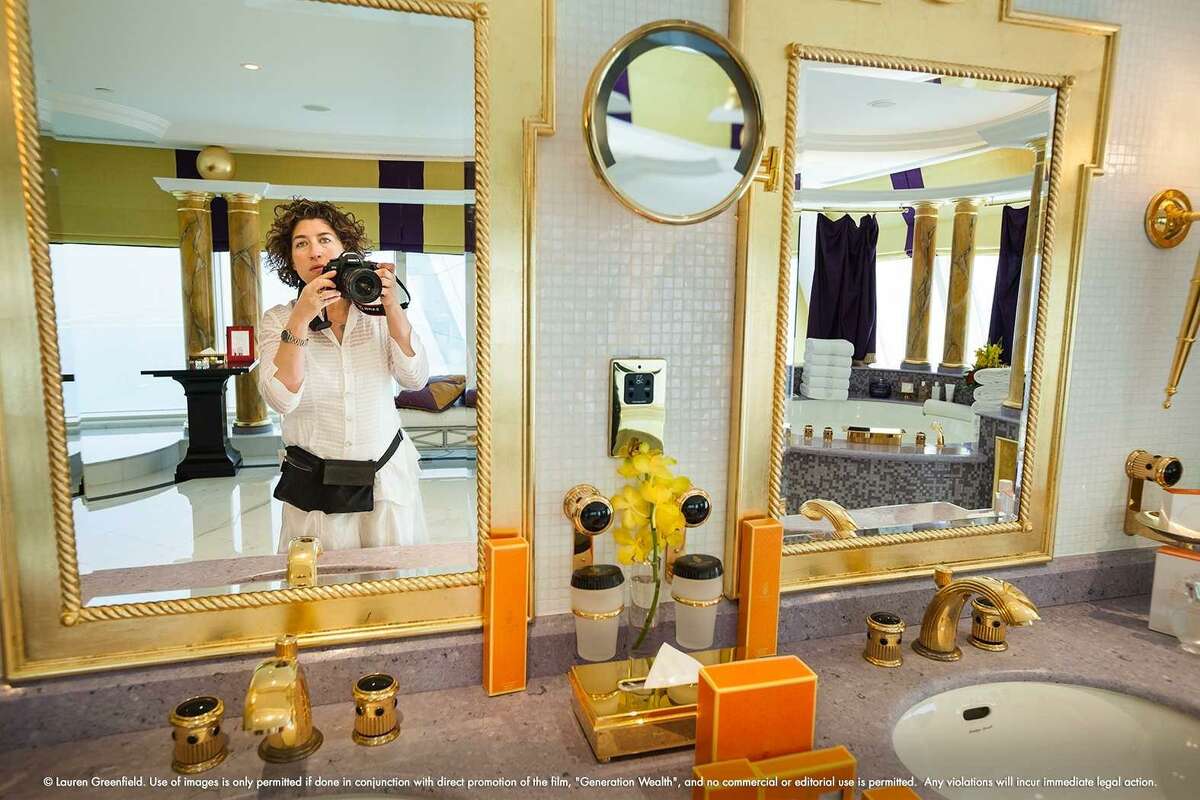 Filmmaker Lauren Greenfield photographs the luxurious presidential suite at the Burj Al Arab hotel in Dubai.