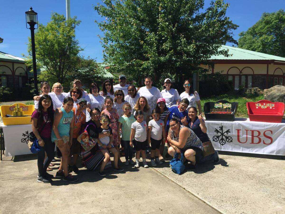 UBS Westport employees participated in the Season of Service activities with Bridgeport-area families at the Wing Ding parade in June.