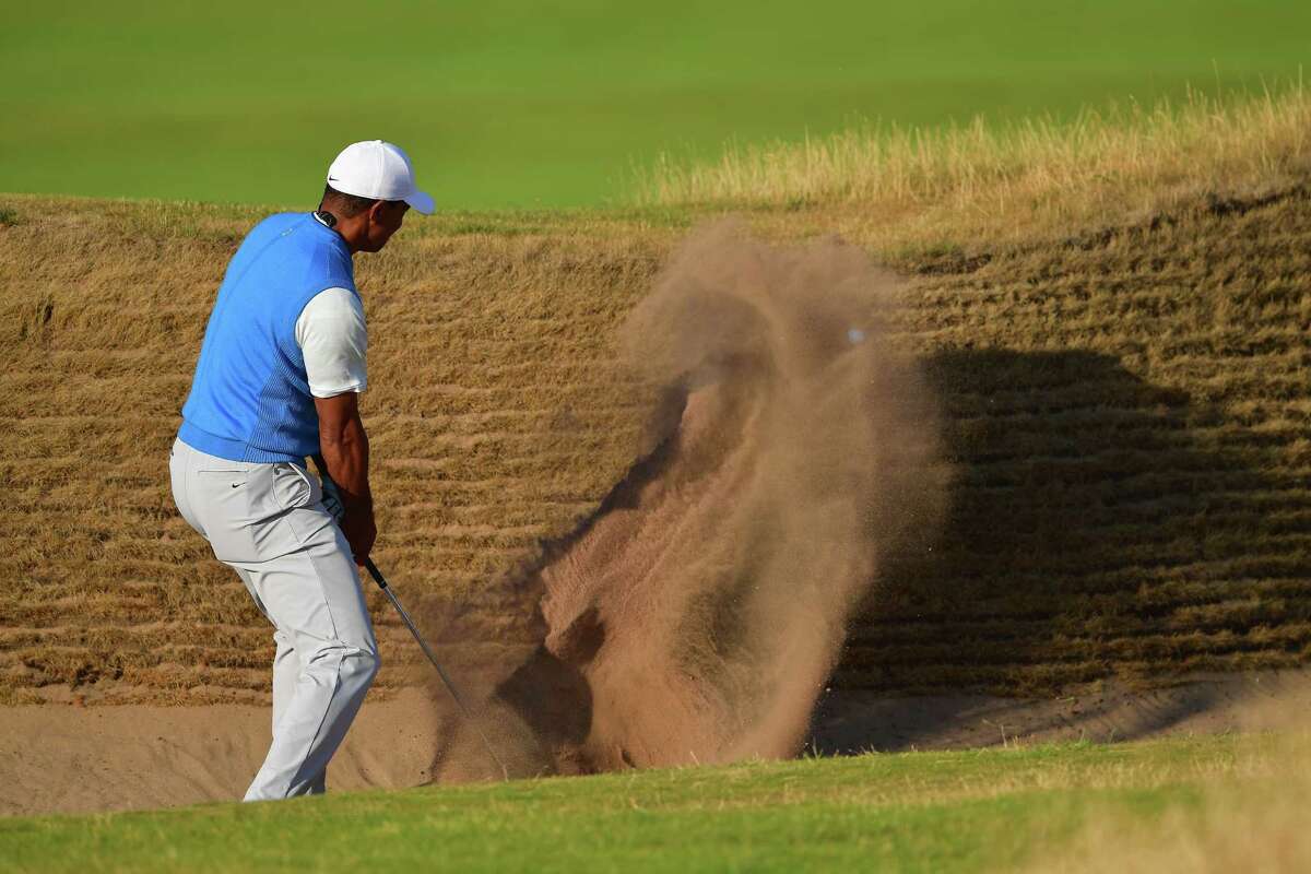 CARNOUSTIE, SCOTLAND - JULY 19: Tiger Woods of the United States hits a bunker shot on the 14th hole during the first round of the 147th Open Championship at Carnoustie Golf Club on July 19, 2018 in Carnoustie, Scotland. (Photo by Stuart Franklin/Getty Images)