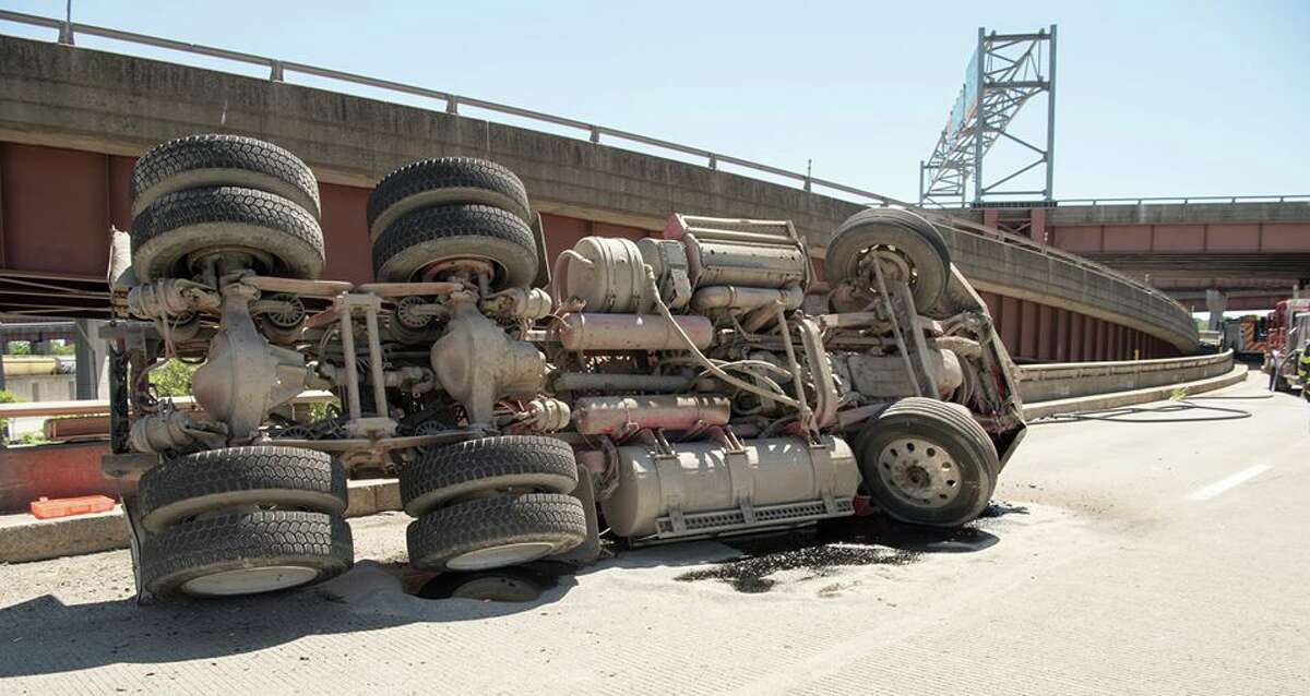 The Albany police and fire departments and the State Police responded to a tractor trailer rollover on Thursday, July 19, 2018, on the ramp from I787 southbound to the Dunn Memorial Bridge and the Empire State Plaza. Roberts Towing and Recovery righted the trailer and helped clear the road. (Steve Smith/Albany Police Department)
