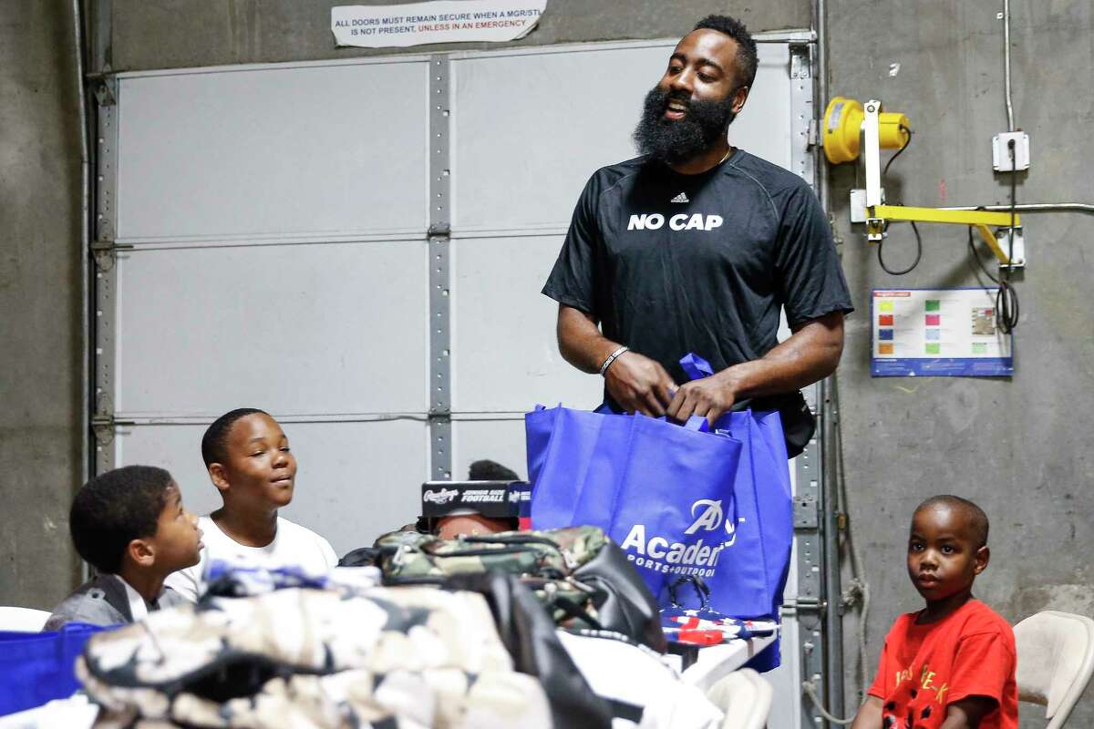 Rockets guard James Harden looks at back to school items after surprising 10 underprivileged kids from the Boys & Girls Club of Greater Houston with a $200 shopping spree at Academy Sports and Outdoors July 20, 2018 in Houston.