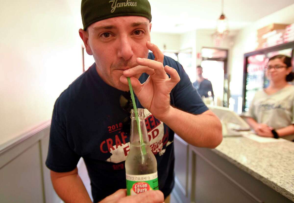 Michael Dupler of Pelham, NY sips a drink at Teena’s Apizza, a Stamford restaurant which opened last month, that only uses recyclable products, including totally compostable staws made from plant material, shown in this photograph taken on July 19, 2018 in Stamford, Connecticut.