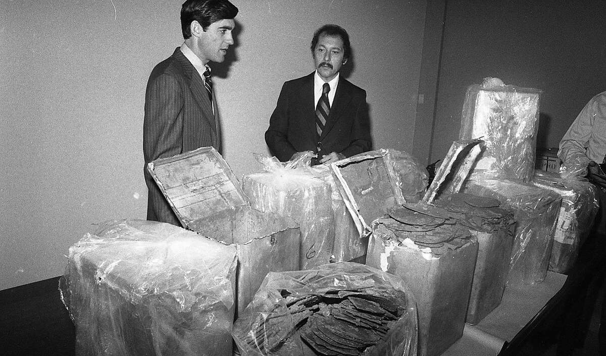 Robert S. Mueller III (l), Assistant U.S. Attorney and Daniel Addario, director DEA regional office inspect hashish from a major bust August 2, 1978