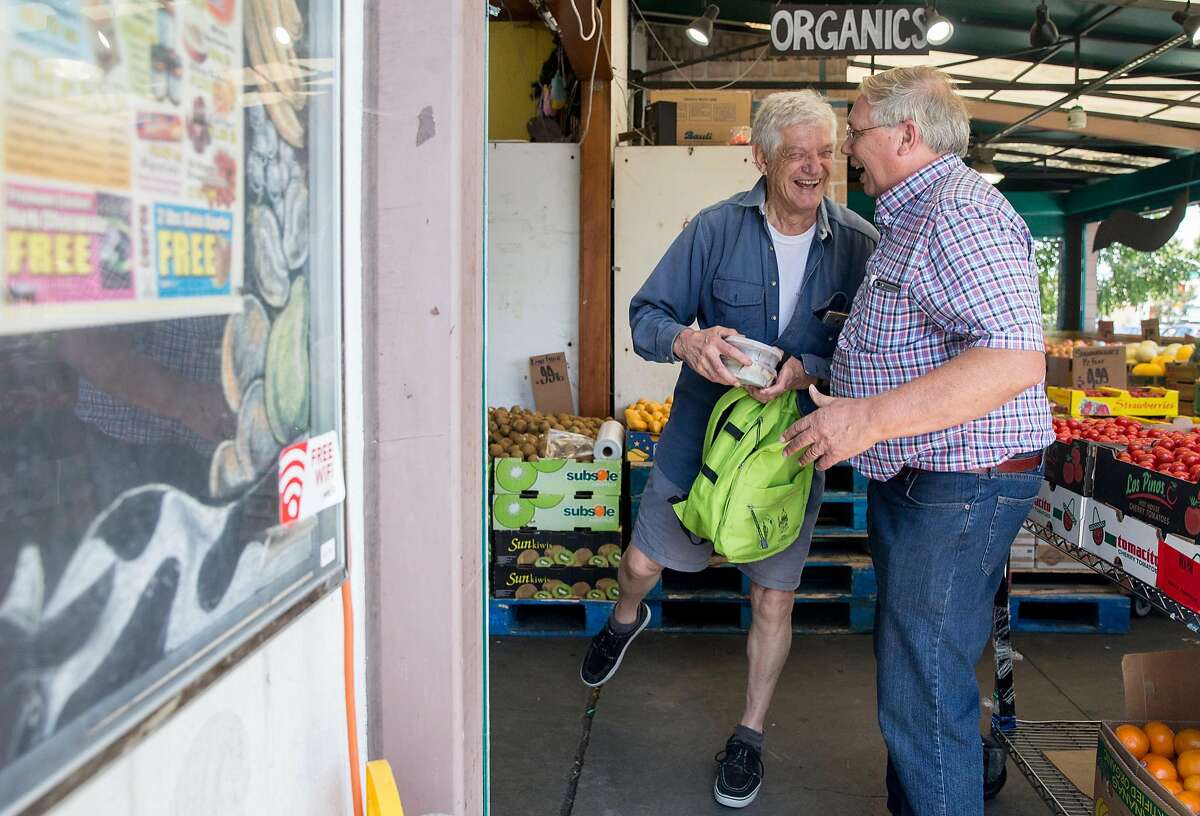 Milk Pail Market owner Steve Rasmussen, right, stops to chat with a customer who gave his name as Hartmut while he shops for groceries in Mountain View, Calif. Wednesday, July 18, 2018.