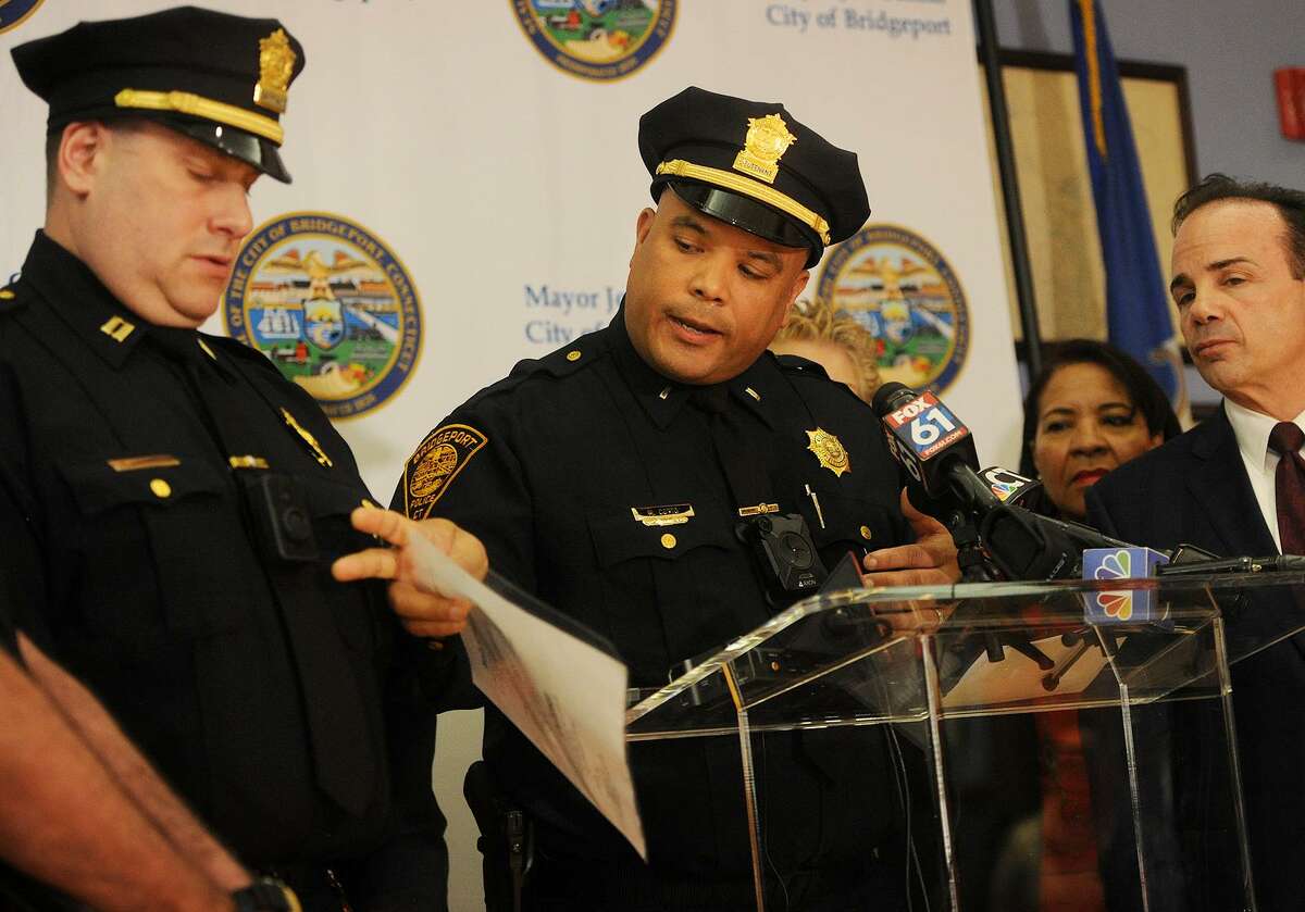 From left; Bridgeport Police Captain Mark Straubel and Lieutenant Manuel Cotto introduce the city's new police body cameras during the program's announcement at the Margaret Morton Government Center in Bridgeport, Conn. on Tuesday, February 20, 2018. At right is Bridgeport Mayor Joe Ganim.