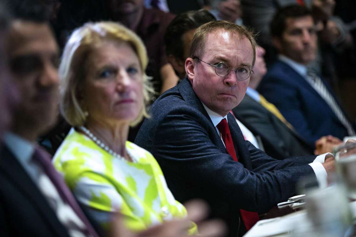 Mick Mulvaney, director of the Office of Management and Budget (OMB), right, shown here June 26, has proposed a merger of the labor and education departments.