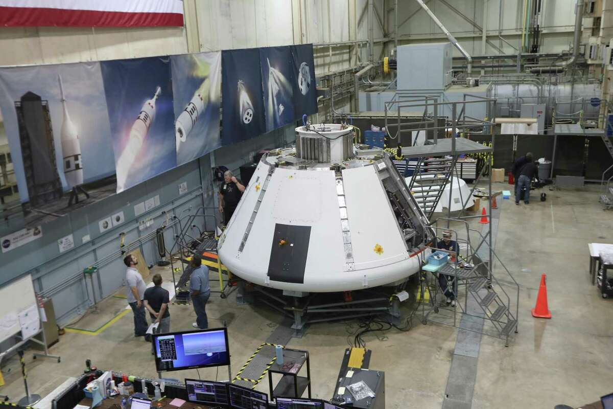 NASA workers prepare the Orion Spacecraft Monday, July 16, 2018, in Houston. Johnson Space Center is powering up the Orion test module to make sure it is functioning well. Since it was delivered to the center in March, officials have been outfitted it with all the avionics, computers, wiring and instrumentation needed. ( Steve Gonzales / Houston Chronicle )