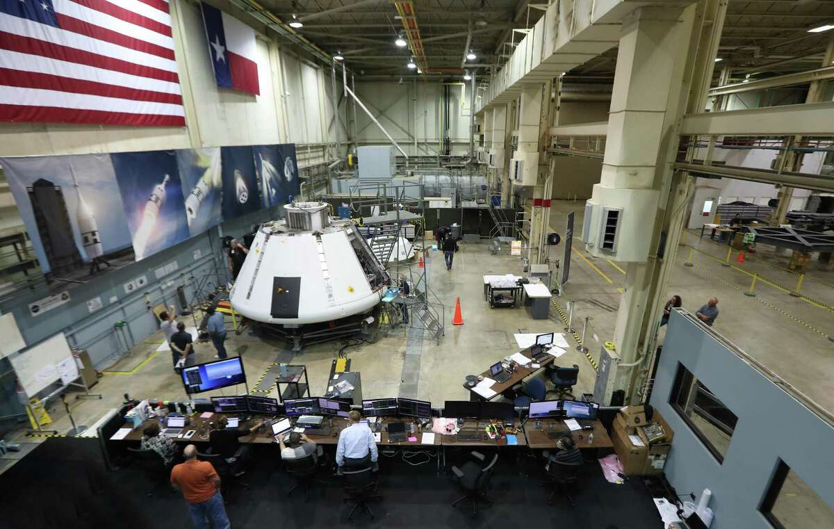 NASA workers prepare the Orion Spacecraft Monday, July 16, 2018, in Houston. Johnson Space Center is powering up the Orion test module to make sure it is functioning well. Since it was delivered to the center in March, officials have been outfitted it with all the avionics, computers, wiring and instrumentation needed. ( Steve Gonzales / Houston Chronicle )