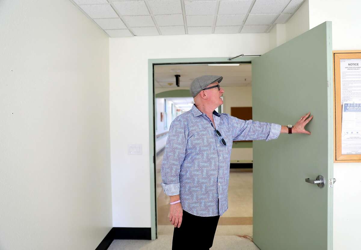 Larry Kamer, of Kamer Consulting Group, looks at a door that was riddled with bullet holes four months ago during a shooting that had multiple fatalities at the Pathway Home in Yountville, Cali. on Friday, July 20, 2018. The Martinez VA is partnering with the Pathway Home to continue treating their patients after its closure.
