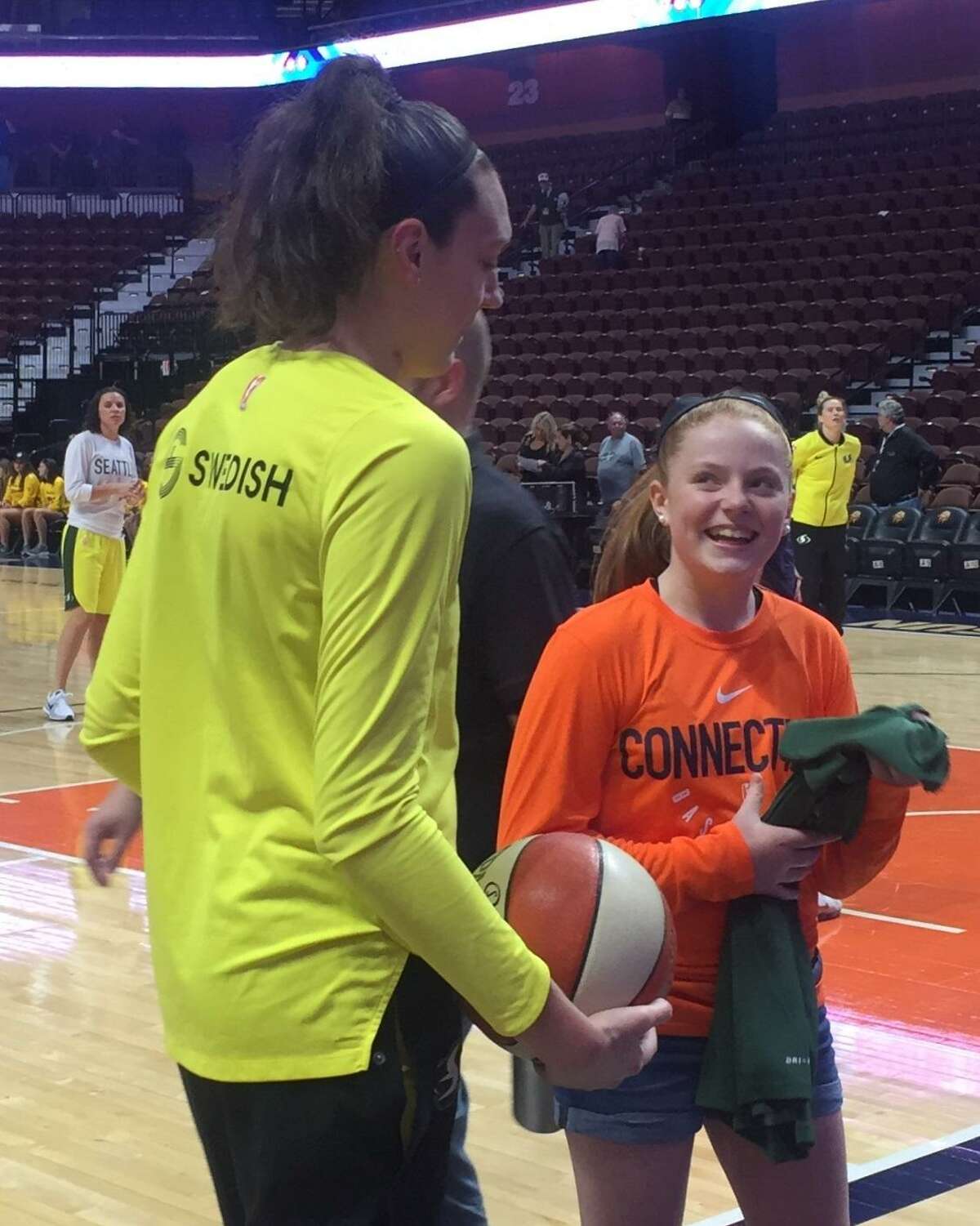 Caroline Hartley from Scarborough, Maine talks with the Seattle Storm’s Breanna Stewart at Friday’s game at Mohegan Sun Arena.