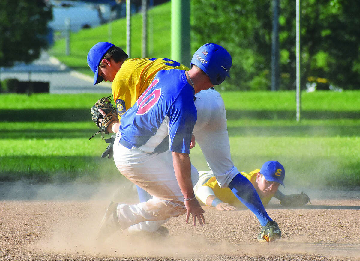 Edwardsville Post 199 infielder Joel Quirin forces out a runner at second base after receiving a flip from Tate Wargo, backgrond, during the District 22 championship game against Belleville at Hoppe Park.