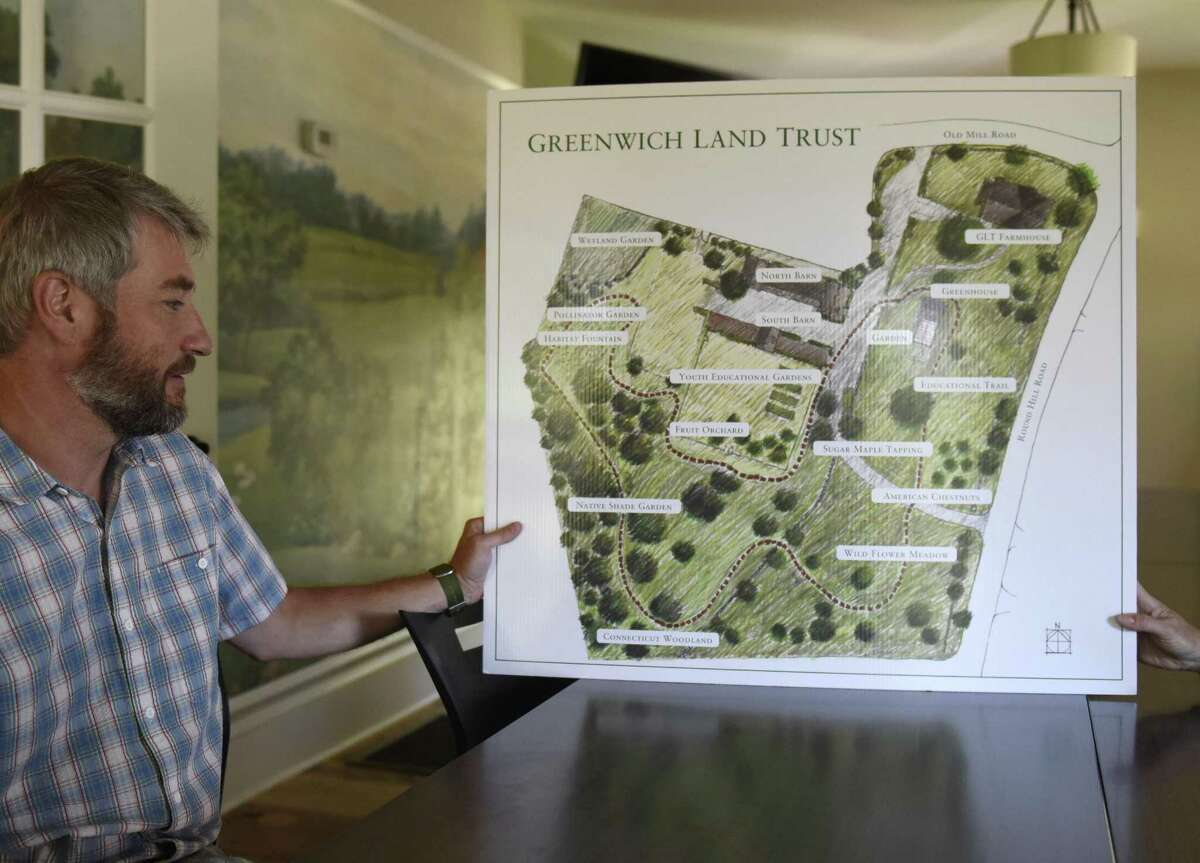 Greenwich Land Trust Executive Director Will Kies shows a map of the new accessible walking trail at the Greenwich Land Trust Mueller Preserve in Greenwich, Conn. Thursday, July 19, 2018. The new trail traverses four acres of land showing a variety of different habitats and ecosystems, a microcosm of those found throughout the town, over the short loop.